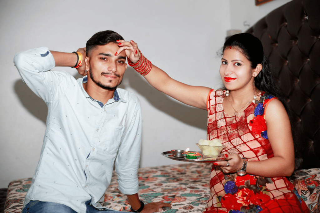 Sister applying tilak on her brother’s forehead during Bhai Dooj celebration