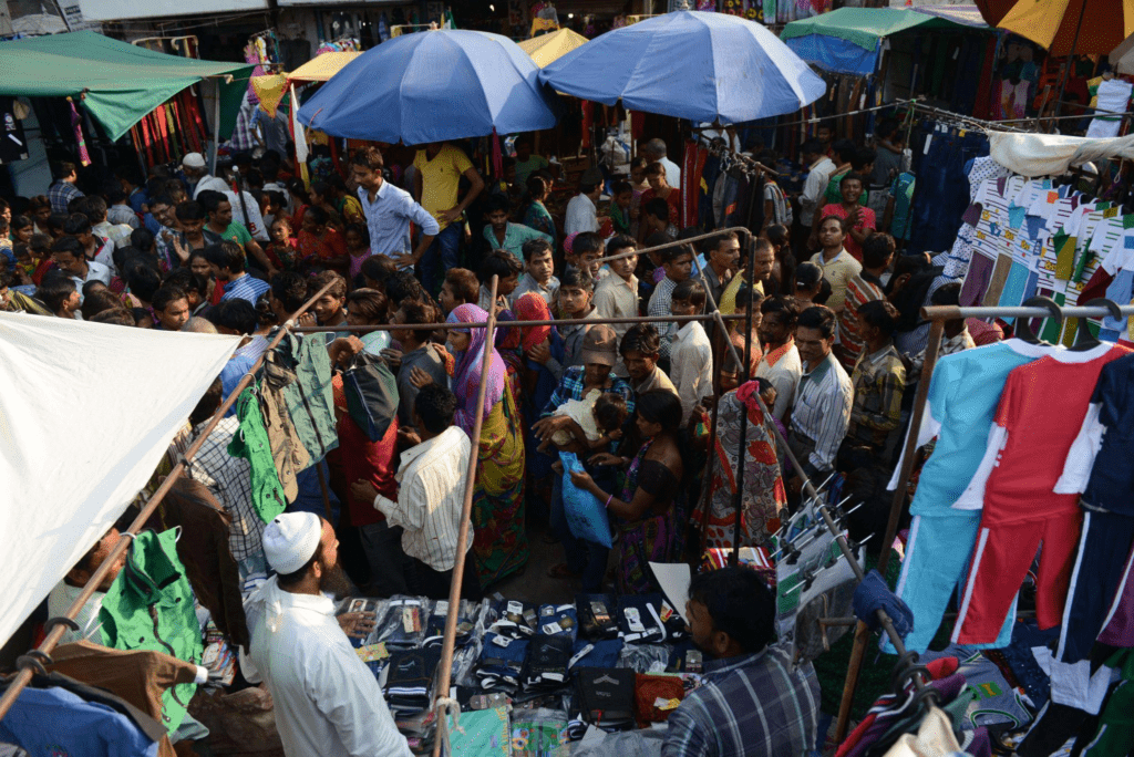 Crowded Indian marketplace during Diwali season as shoppers purchase gold, sweets, and festive goods