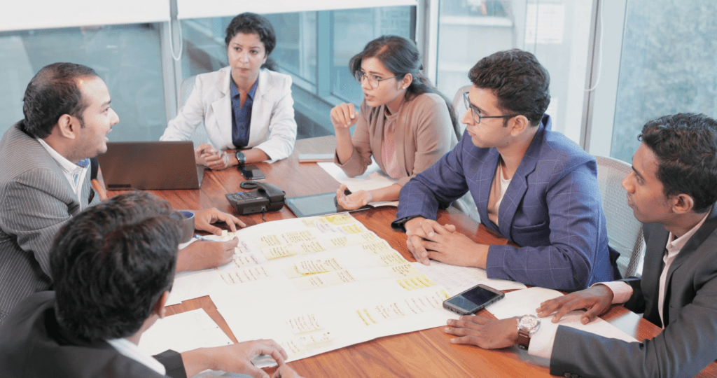 Government employees reading updates about the 8th Pay Commission implementation timeline