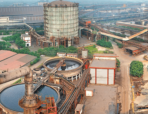 Industrial steel plant and IT campus representing sectors impacted during stock market decline